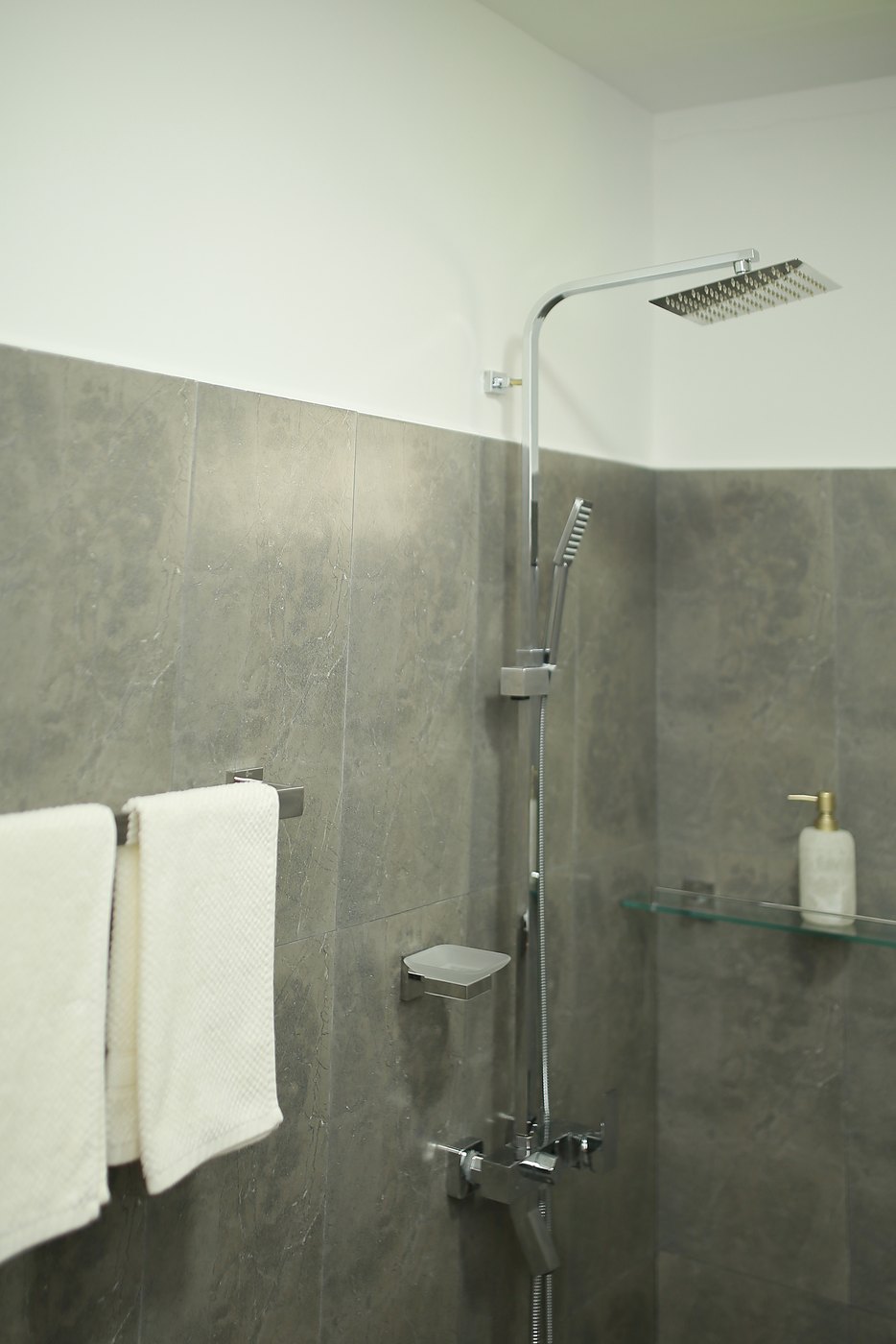 Rain shower with fresh white towels in an ensuite