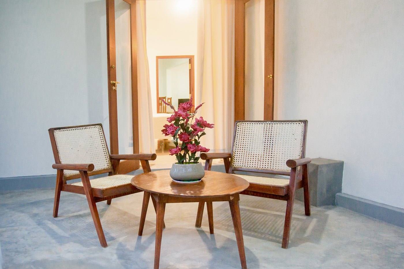 Rattan chairs and a teak table on the verandah